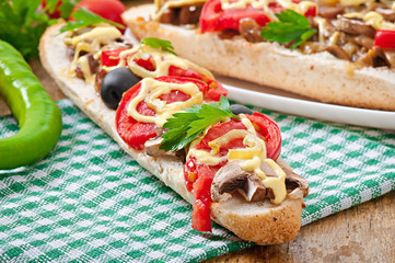 Baguette stuffed with veal and mushrooms with tomatoes 