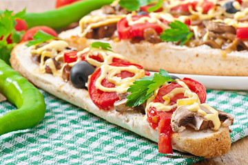 Baguette stuffed with veal and mushrooms with tomatoes 