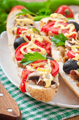 Baguette stuffed with veal and mushrooms with tomatoes 