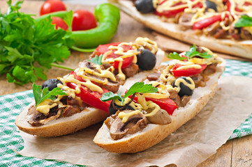 Baguette stuffed with veal and mushrooms with tomatoes 