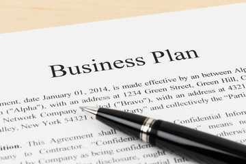 Business plan document with pen