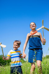 Kids in summer day holds windmill