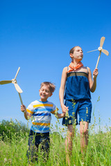 Kids in summer day holds windmill