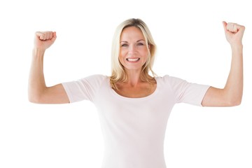 Happy blonde cheering and smiling at camera