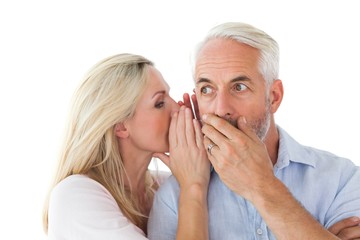 Woman whispering a secret to husband