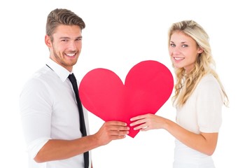 Attractive young couple holding red heart