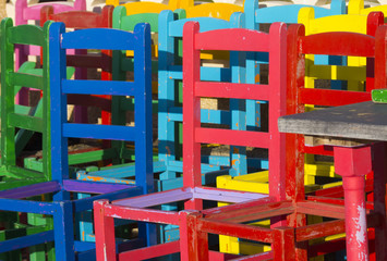 many chairs of different colors together