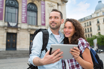 Young couple of tourists visiting city