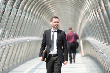 Young attractive businessman on the way to his job