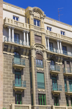 nice old building with highly decorated facade and large windows