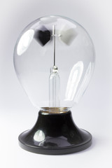 old Crookes radiometer operating on white background
