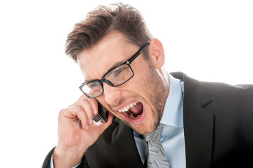 Angry businessman yelling into cellphone on white.