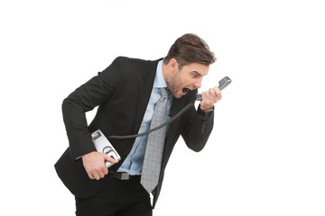 Angry businessman yelling into landline phone on white