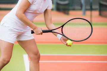 Focused tennis player ready to serve