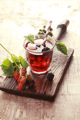 Glass of fruit juice with fresh blackberries