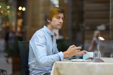 Young fashion man / hipster drinking coffee with tablet computer