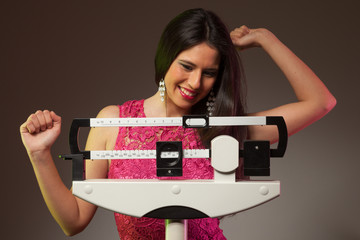 Happy woman on the scale