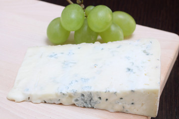 Gorgonzola blue cheese on wooden chopping board