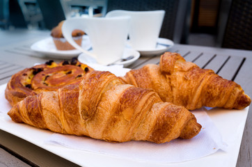 Breakfast with coffee and croissants