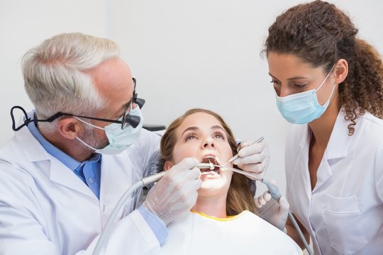 Dentist examining a patients teeth