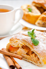 slice of an apple strudel with tea