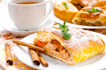 slice of an apple strudel with tea