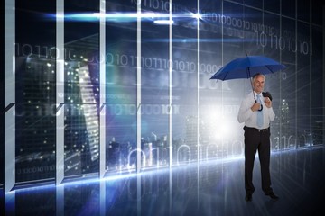 Composite image of happy businessman holding umbrella