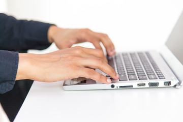 hands typing on laptop keyboard
