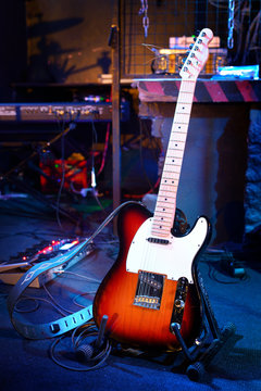Electric guitar and other musical equipment on stage before conc