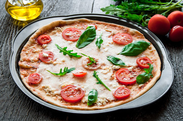 rustic italian pizza with mozzarella, cheese and basil