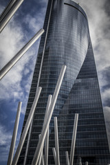 Fototapeta na wymiar financial, skyscraper with glass facade and clouds reflected in