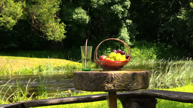 grape peach fruits and glass with champagne cider on millstone