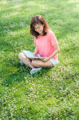 woman reading a book in the garden