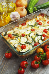 Zucchini baked i with chicken, cherry tomatoes and herbs