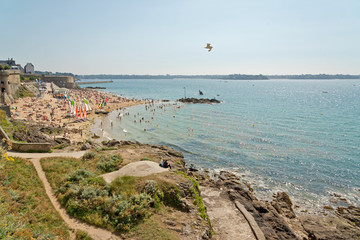 Beach of Saint Malo in summer with tourists and blue sky. Britta