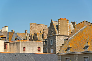 Roofs and houses of Saint Malo in summer with blue sky. Brittany