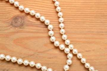 pearl necklace on wood