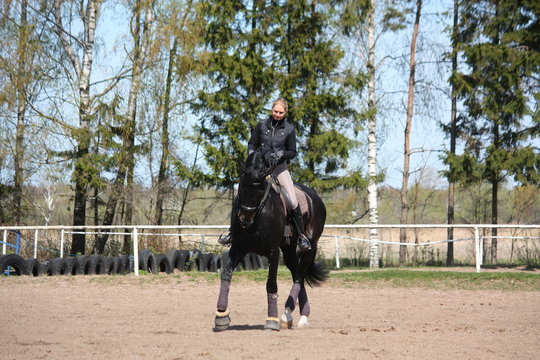 Woman riding black horse