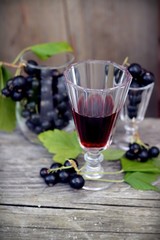 berries and blackcurrant leaves with drink of black currant