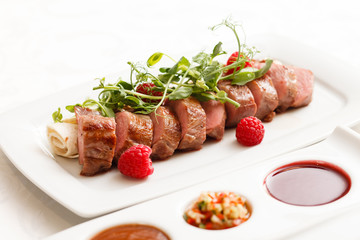 grilled duck breast covered with sweet red fruit sauce