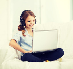girl with laptop computer and headphones at home