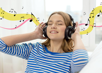 smiling young girl in headphones at home