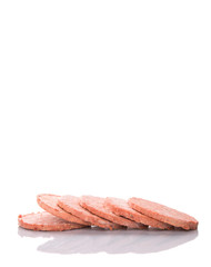 Frozen raw hamburger beef meat over white background