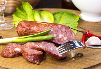 sausages on a wooden plate with vegetables in a restaurant