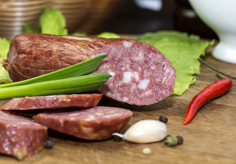 sausages on a wooden plate with vegetables in a restaurant