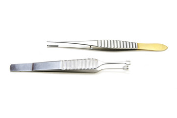 steel surgical instruments on a white background