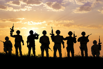 silhouette of  Soldiers team with sunrise background - Powered by Adobe