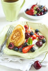 Homemade pancakes with fresh fruits salad and yogurt