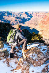 Hiker looks into depth of Grand Canyon before going on the trail