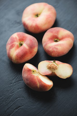 Ripe chinese flat peaches, close-up, studio shot
